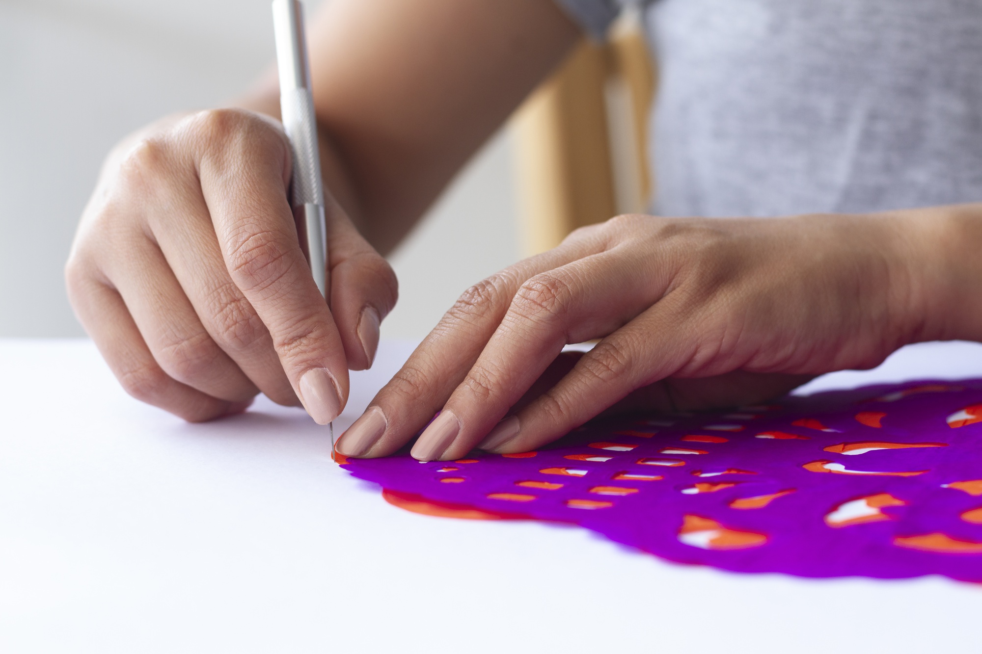 Hands stitching a modern geometric pattern